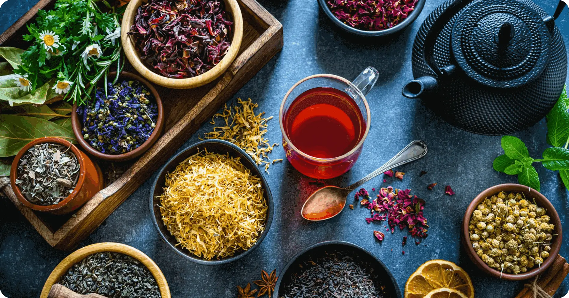 Assorted herbal teas and ingredients on table.